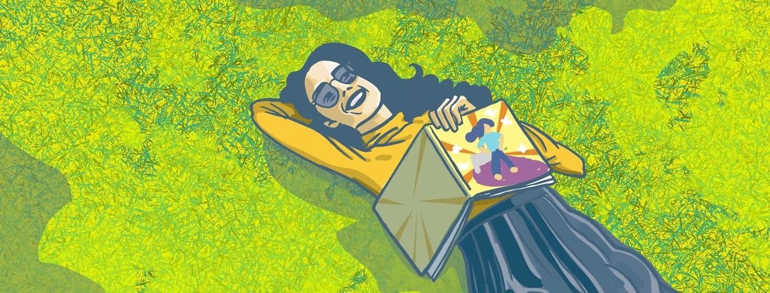 The main character in the book lays in the grass with the book on her lap