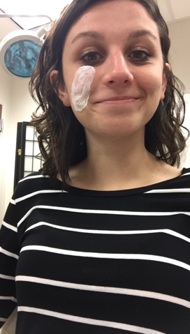 Girl with a happy face and a bandaid on her cheek