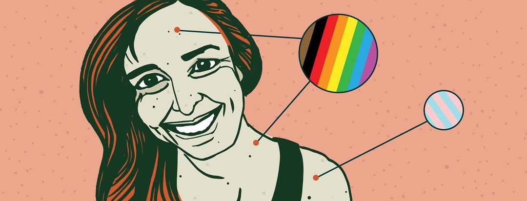 zoomed in circles show gay pride and trans pride flags on a woman's skin