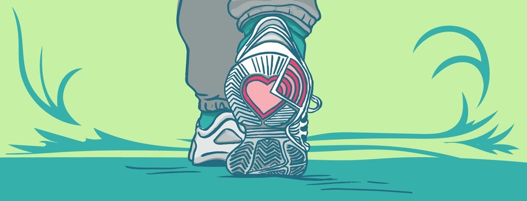A pair of sneakers with a heart showing on the bottom