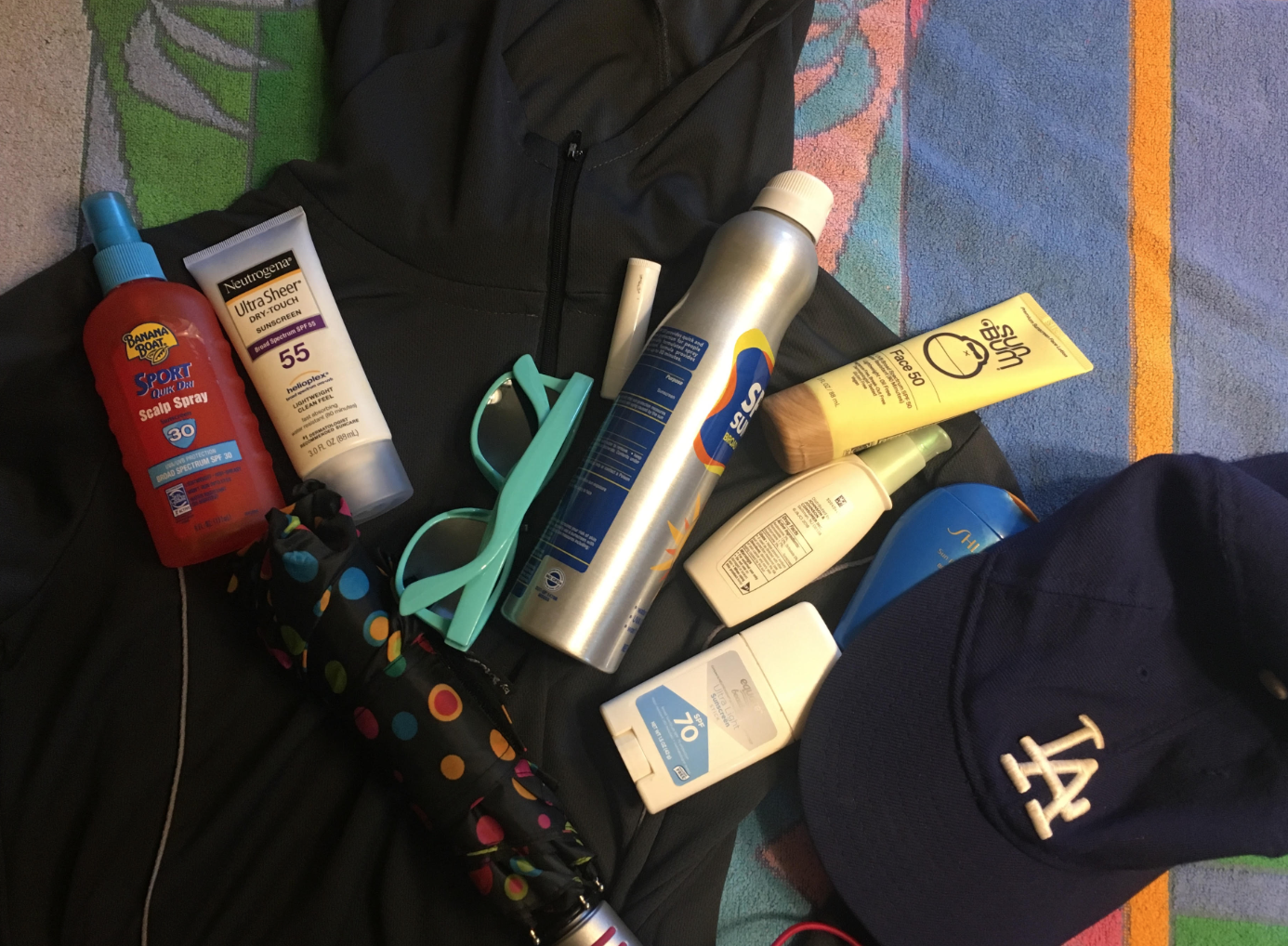 Scott's pile of sunscreen and hats and sunglasses