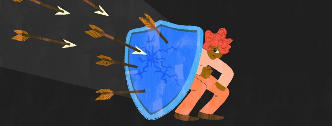 A person cowers behind a cracked shield with arrows approaching it.
