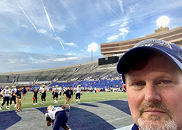 Ken Billett in front of Memphis Tigers football field.